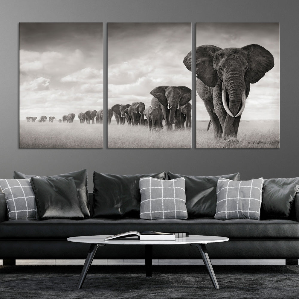 The "Herd of Elephants Wall Art Canvas Print" features an elegant black and white triptych of elephants walking in a line, beautifully displayed on museum-quality canvas with a UV-protective coating. This artwork arrives ready to hang and adds sophistication to any space.