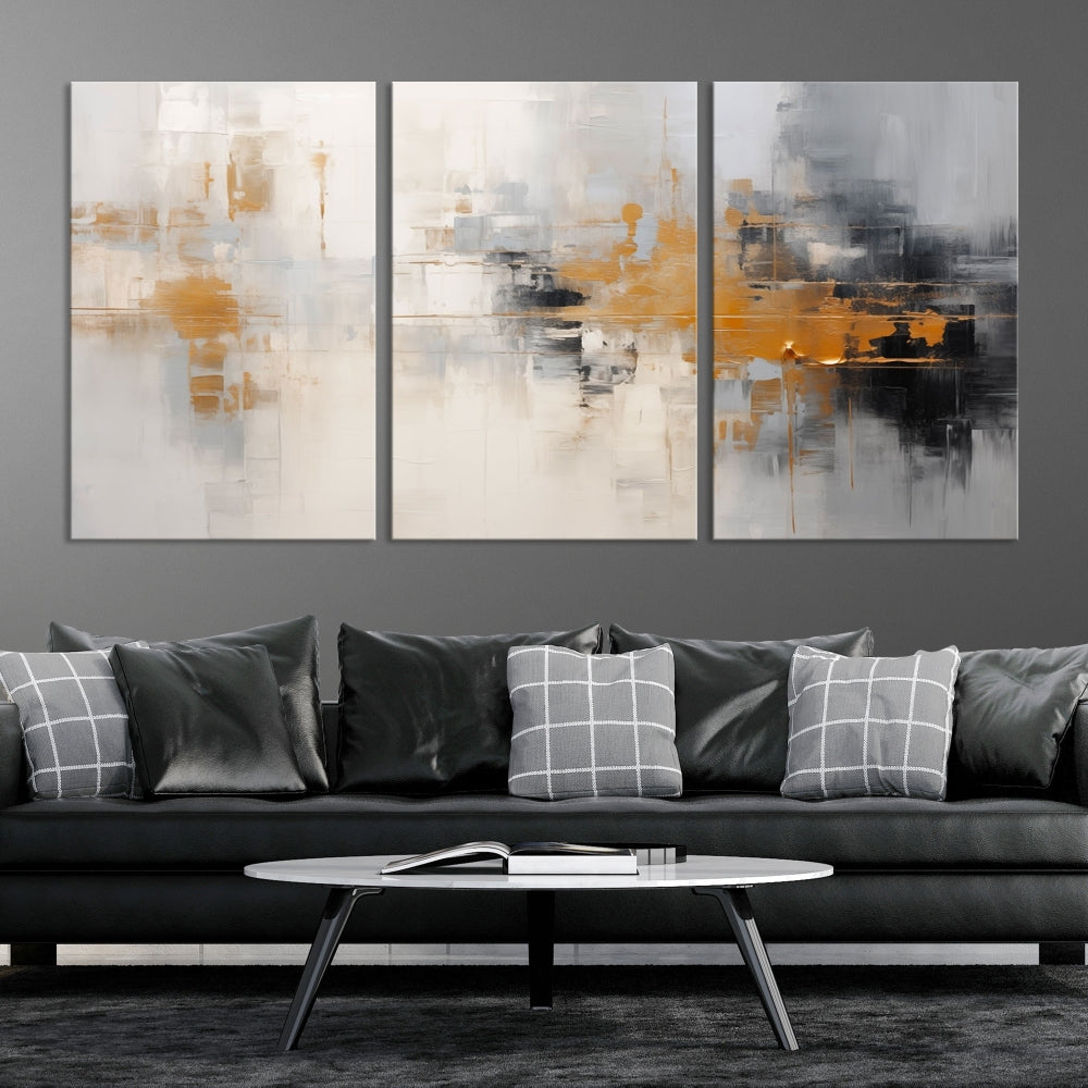 The Orange Pastel Abstract Wall Art Canvas Print, featuring a triptych of orange, white, and black hues, is elegantly displayed on museum-quality canvas.