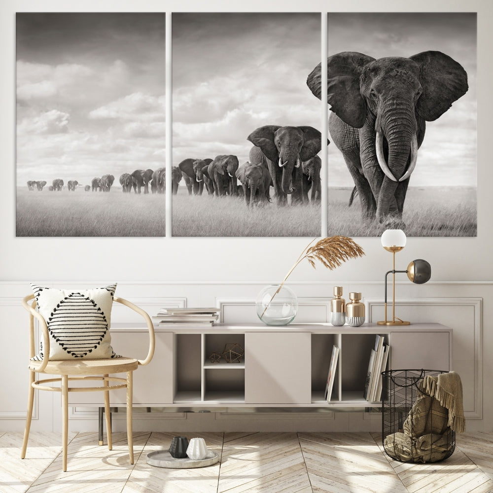 The "Herd of Elephants Wall Art Canvas Print" features an elegant black and white triptych of elephants walking in a line, beautifully displayed on museum-quality canvas with a UV-protective coating. This artwork arrives ready to hang and adds sophistication to any space.