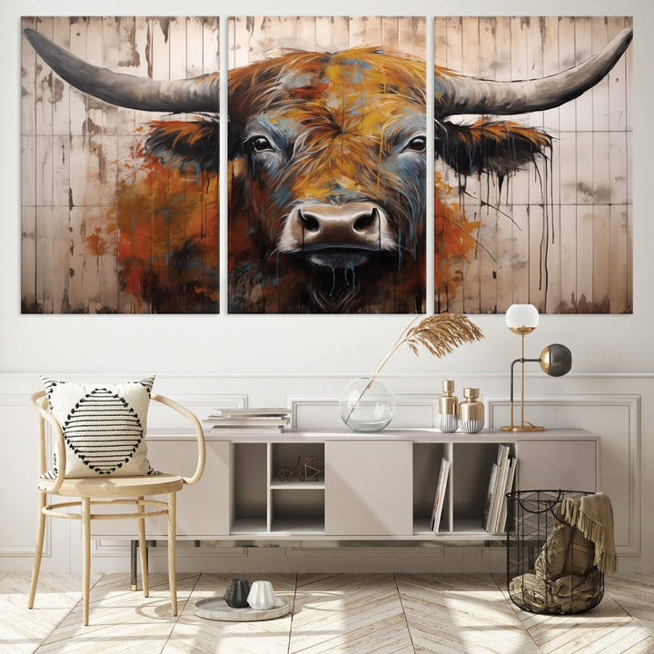 The Abstract Bull Highland Cow Canvas Wall Art Print, featuring its large horns, is mounted on a white wall, introducing a vibrant rustic charm that enhances the modern farmhouse style.