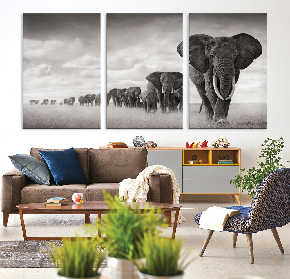 The "Herd of Elephants Wall Art Canvas Print" features an elegant black and white triptych of elephants walking in a line, beautifully displayed on museum-quality canvas with a UV-protective coating. This artwork arrives ready to hang and adds sophistication to any space.