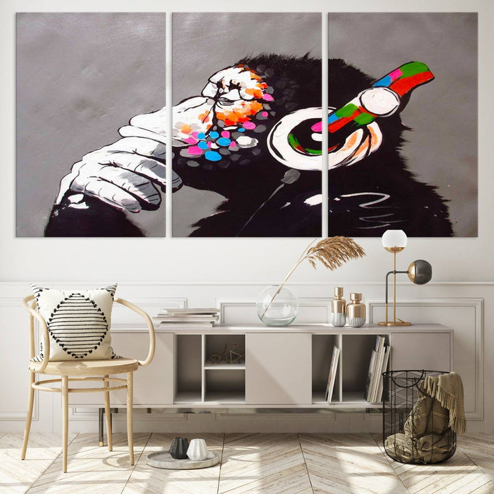 A vibrant triptych, the "DJ Monkey Listening to Music" wall art print, features a Banksy-inspired large canvas adorned with colorful modern pop art. This striking piece elegantly enhances the room with its dynamic and lively depiction.