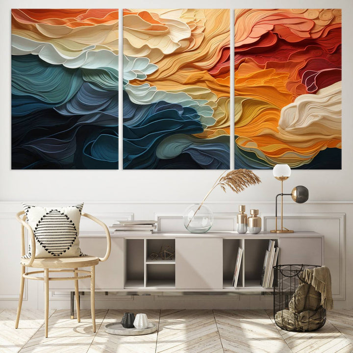 A Blue Orange Abstract Wave Wall Art Canvas Print adorns the wall. This colorful masterpiece is professionally hand-assembled to enhance any space.