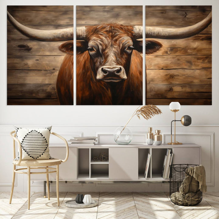 The Longhorn Bull Wall Art, a ready-to-hang canvas print, showcases an image of a brown longhorn cow set against a wooden background, perfect for those looking to enhance their space with rustic farmhouse and western barn decor.