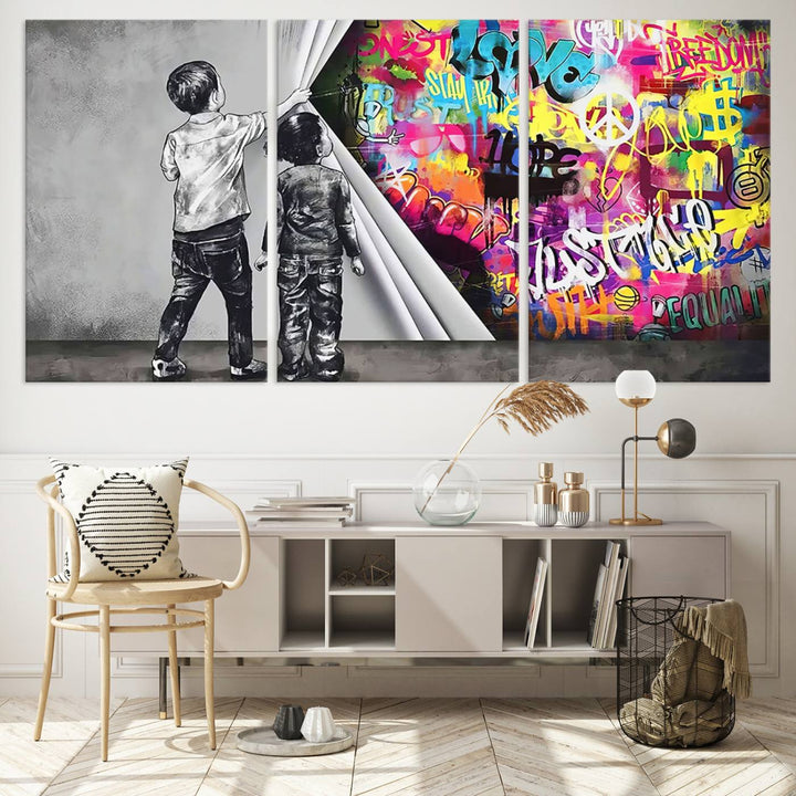 The Banksy Print - Street Art Canvas features a vibrant and bold image of two children lifting a curtain to reveal colorful graffiti. It's ready to hang, adding an urban modern decor vibe.