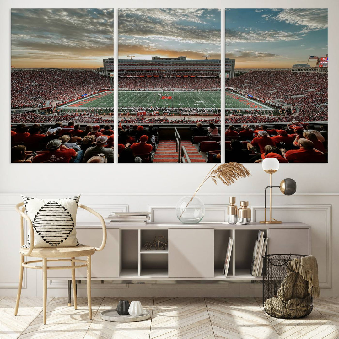 The living room features a stunning triptych of Lincoln Memorial Stadium wall art canvas print, celebrating the University of Nebraska Cornhuskers football team. This piece serves as captivating wall art, showcasing a gallery-quality finish.