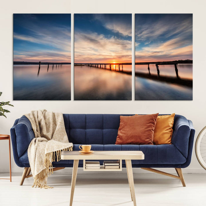 The Sunset Pier Canvas features a serene coastal landscape with vibrant hues under cloudy skies, ideal for modern decor.