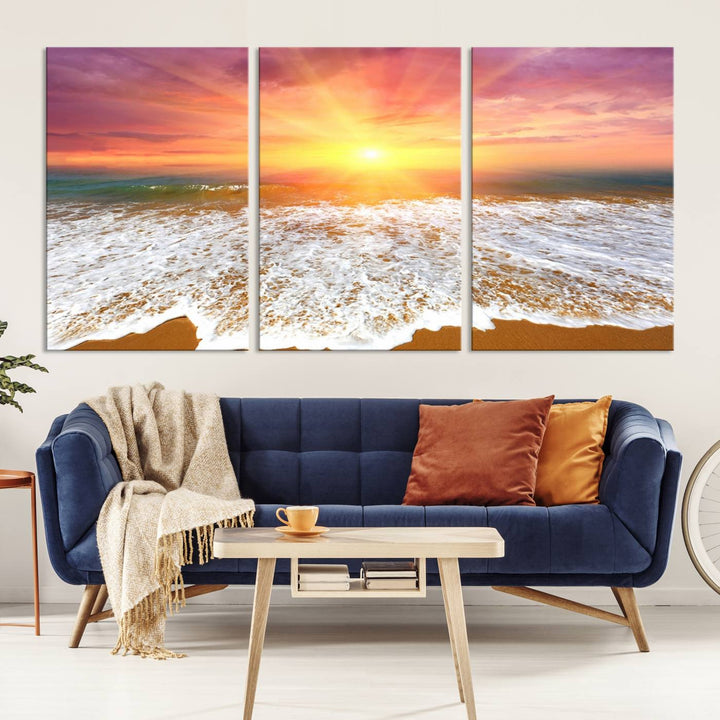 Golden Beach Sunrise 3-panel canvas art of ocean waves, hung on a wooden wall.