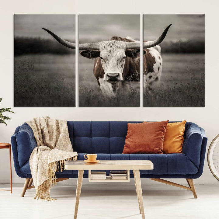 The Texas Longhorn Cow Canvas Wall Art Print adds a rustic touch to a living room.