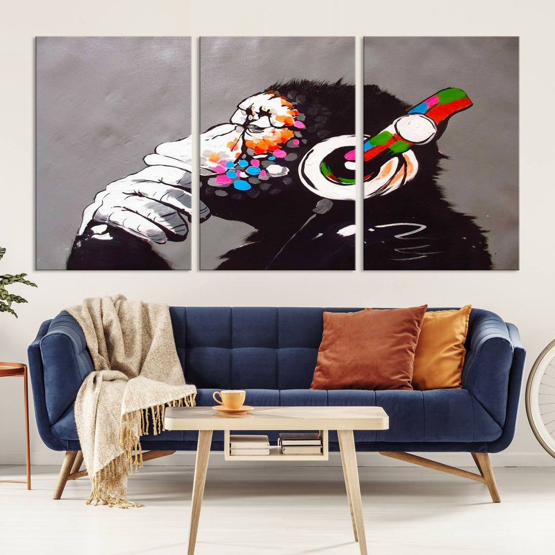 A vibrant triptych, the "DJ Monkey Listening to Music" wall art print, features a Banksy-inspired large canvas adorned with colorful modern pop art. This striking piece elegantly enhances the room with its dynamic and lively depiction.