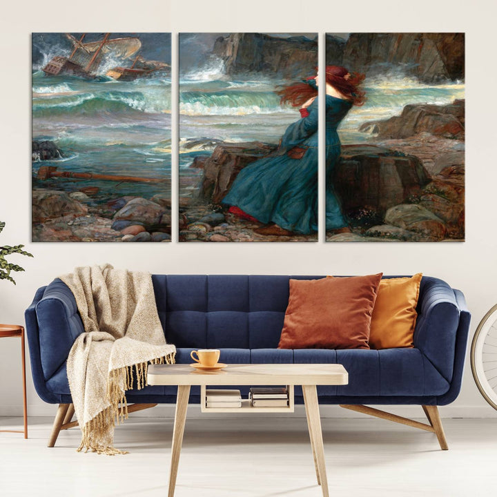 The Miranda by the Shore Wall Art Canvas Print depicts a woman in a blue dress standing by the sea, watching a shipwreck.