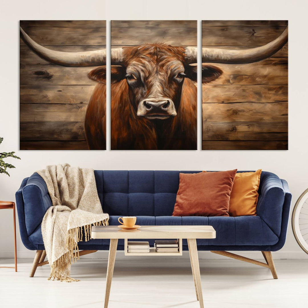 The Longhorn Bull Wall Art, a ready-to-hang canvas print, showcases an image of a brown longhorn cow set against a wooden background, perfect for those looking to enhance their space with rustic farmhouse and western barn decor.