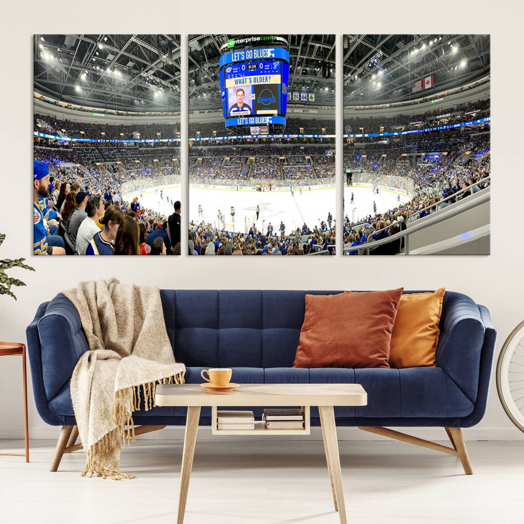 Wall art prints depicting the bustling scenes of the St. Louis Blues being cheered on by a full house at the Enterprise Center, beneath a large scoreboard.