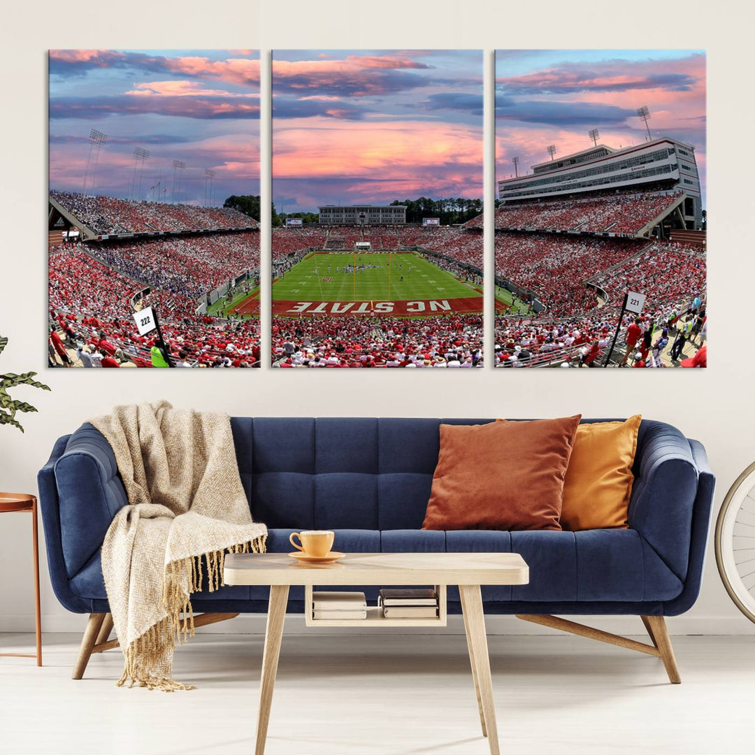 The wall art captures an NC State Wolfpack game under a vibrant sunset on triple canvas.