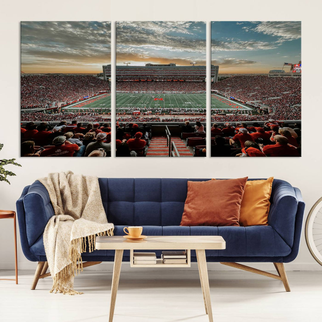 The living room features a stunning triptych of Lincoln Memorial Stadium wall art canvas print, celebrating the University of Nebraska Cornhuskers football team. This piece serves as captivating wall art, showcasing a gallery-quality finish.