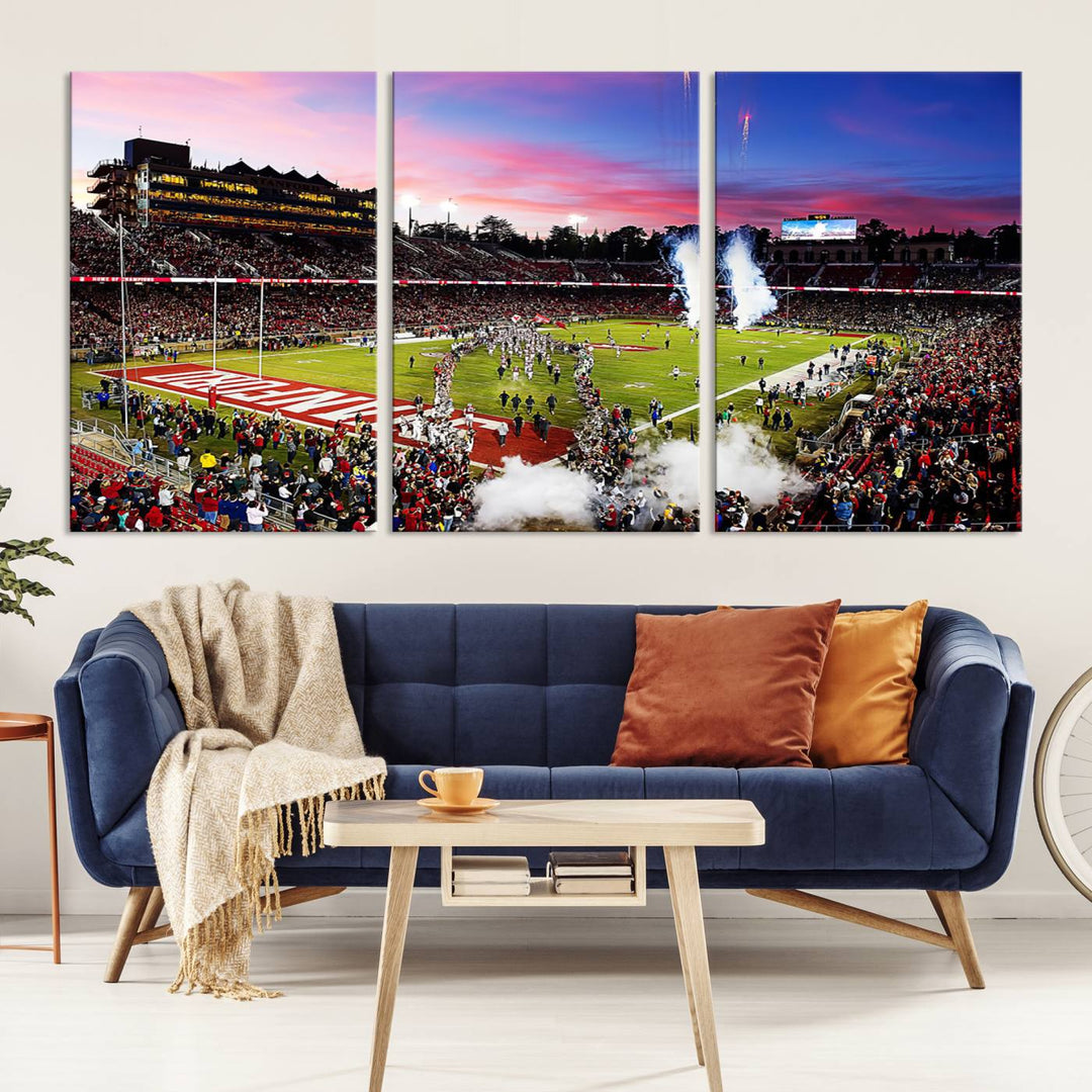 The wall art features a canvas print of the Stanford Cardinal football team, capturing players, fireworks, and smoke against the backdrop of a sunset at Stanford Stadium.