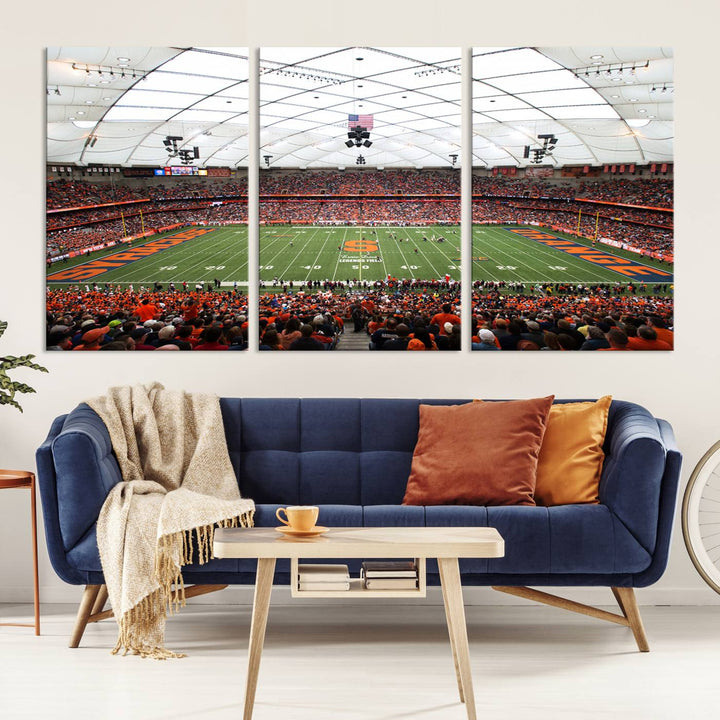 Fans fill the Syracuse JMA Wireless Dome, highlighted in orange and blue under a vaulted roof on this premium canvas print of the scene.