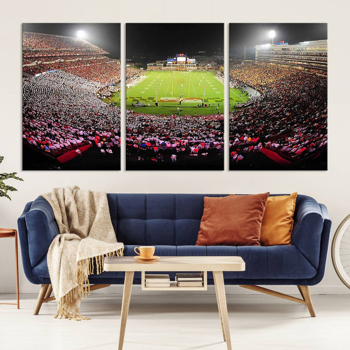 The Maryland Terrapins Football Wall Art Canvas showcases a packed SECU Stadium at night with a bright field and cheering fans.