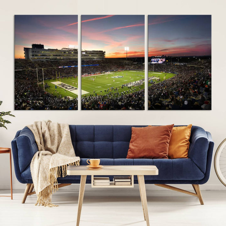 This wall art canvas print captures UCONN Huskies fans energizing a sunset scene at East Hartfords Pratt & Whitney Stadium.