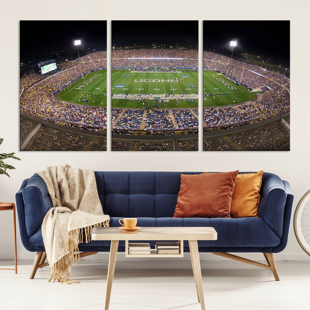 A large football stadium at night, featuring the UCONN Huskies, is depicted on the East Hartford Pratt & Whitney Stadium Wall Art Canvas Print.