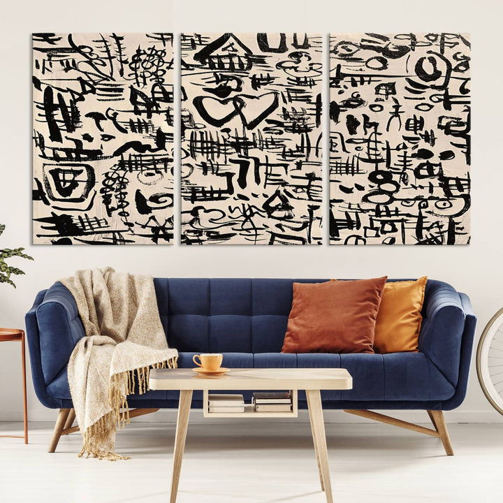 The Abstract Love and Chaos canvas is a museum-quality print featuring black symbols on a beige background, adorned with a heart and scribble design. It is framed to enhance its artistic appeal.