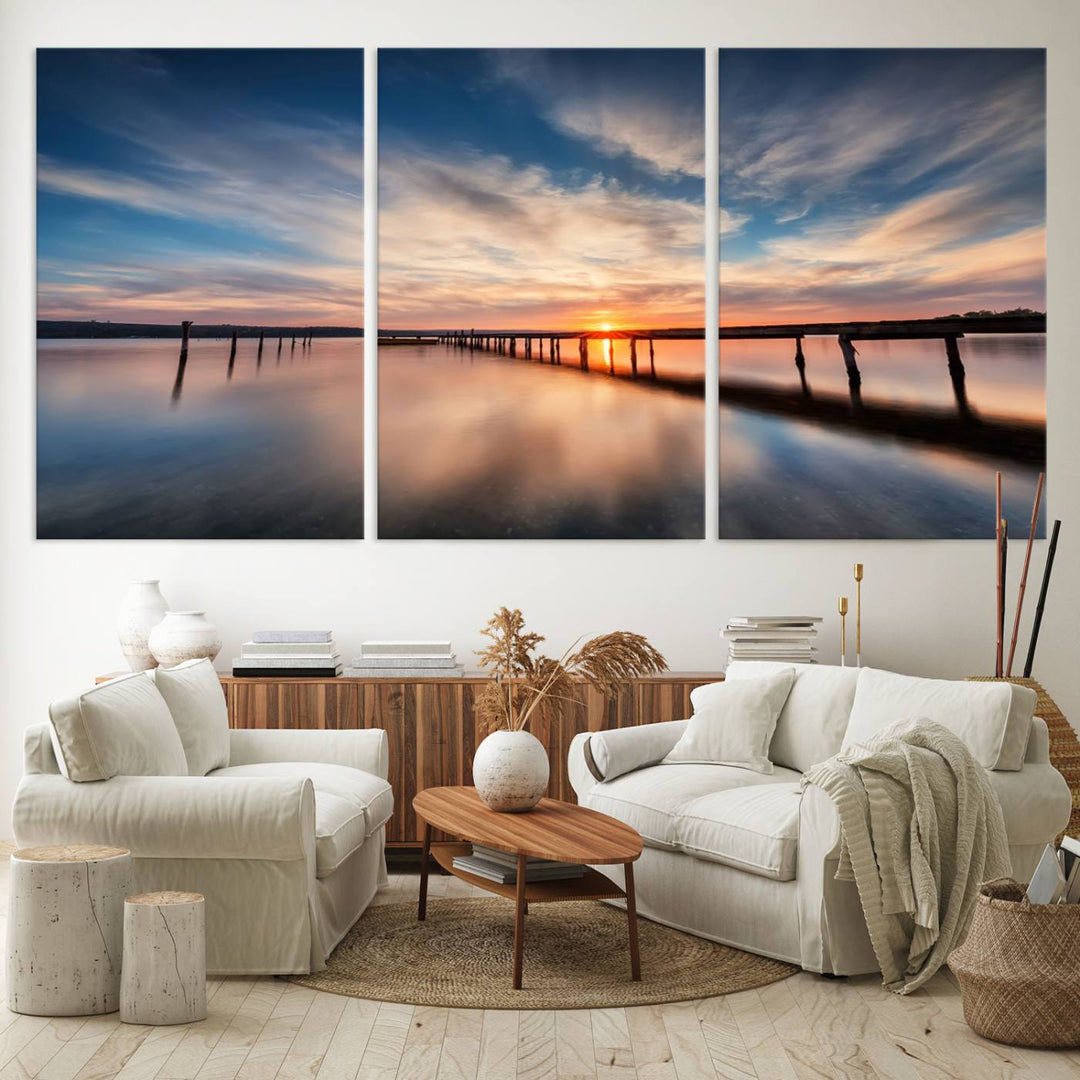 The Sunset Pier Canvas features a serene coastal landscape with vibrant hues under cloudy skies, ideal for modern decor.