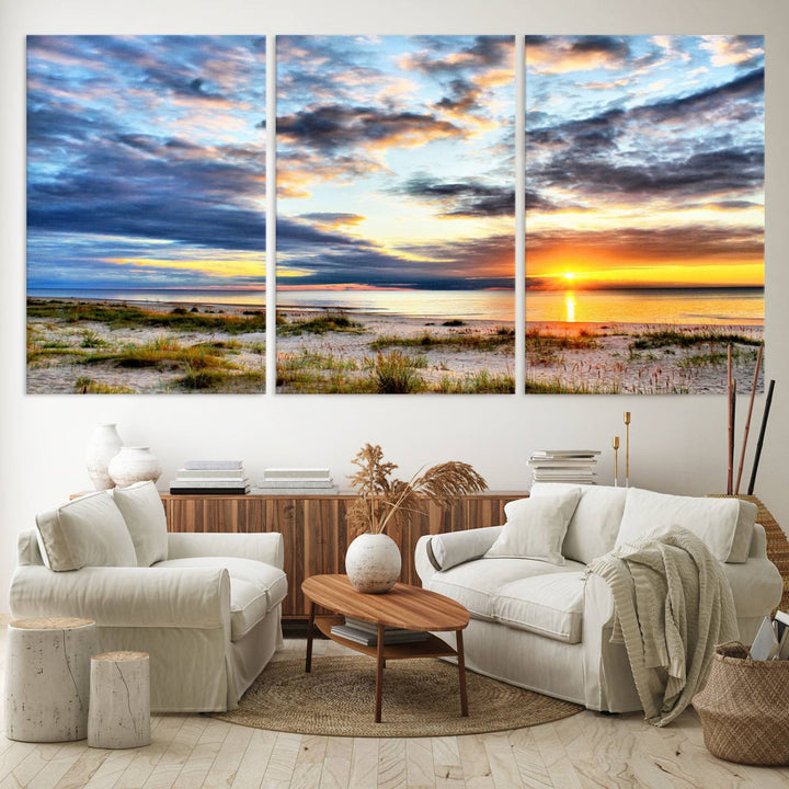 The Sunset On The Ocean canvas wall art features a beautiful beach sunset with grass and clouds.