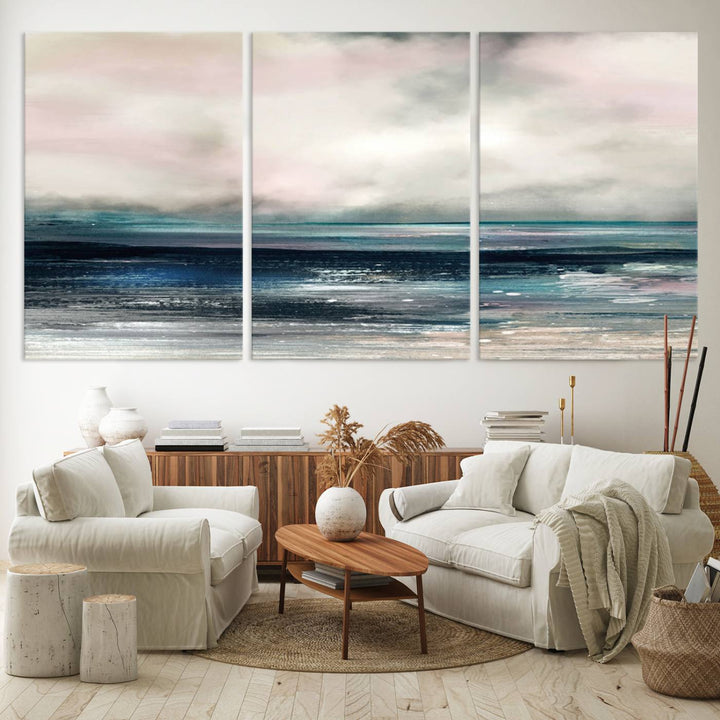 A contemporary abstract wall art canvas print in pastel pink, teal, and gray tones hangs on the wall.