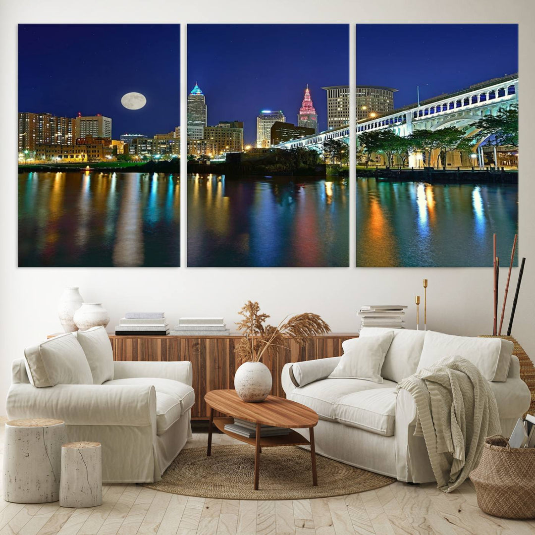 Cleveland City Lights Night Skyline Wall Art canvas showcases a moonlit cityscape reflected on water.