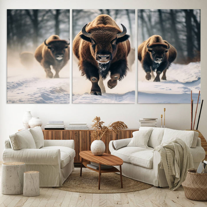 Wall art titled Cow Bighorn shows three bison running through snow in a forest.