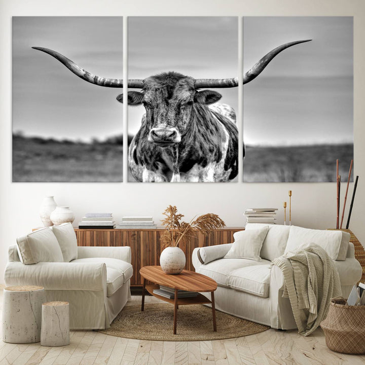 The Texas Longhorn Cow wall art, divided into three panels, is of gallery quality and displayed on a dark wall.