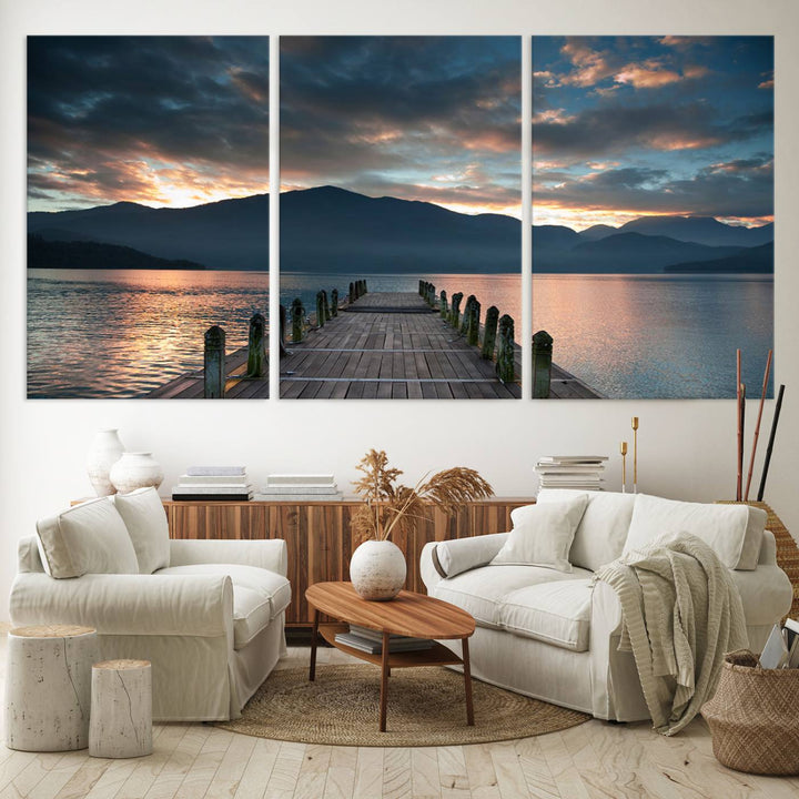 The Mountain Lake Wood Pier Canvas Wall Art depicts a serene lake and mountains, enhancing the beauty of any space.