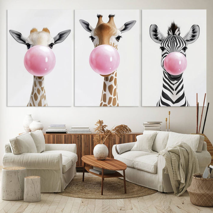 The Bubblegum Animals Canvas Wall Art, featuring a playful trio of giraffe and zebra portraits blowing pink bubblegum, brings charm and whimsy to your space. Ideal for nursery wall art or any fun area, this delightful decor piece is ready to hang and perfect for creating a playful atmosphere.