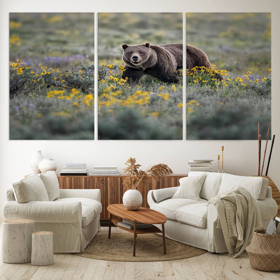 The "Grizzly 399 in Wild Flowers Wall Art Canvas Print" features a grizzly bear strolling through a field of yellow and purple flowers, beautifully showcased as a triptych. This handcrafted piece, proudly made in the USA, adds charm and sophistication to your space.