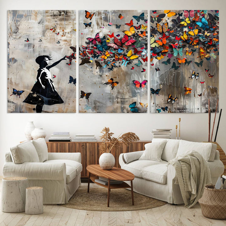 The Banksy Butterfly Girl 3-Piece Modern Graffiti Canvas Wall Art features a silhouette of a girl reaching for butterflies.