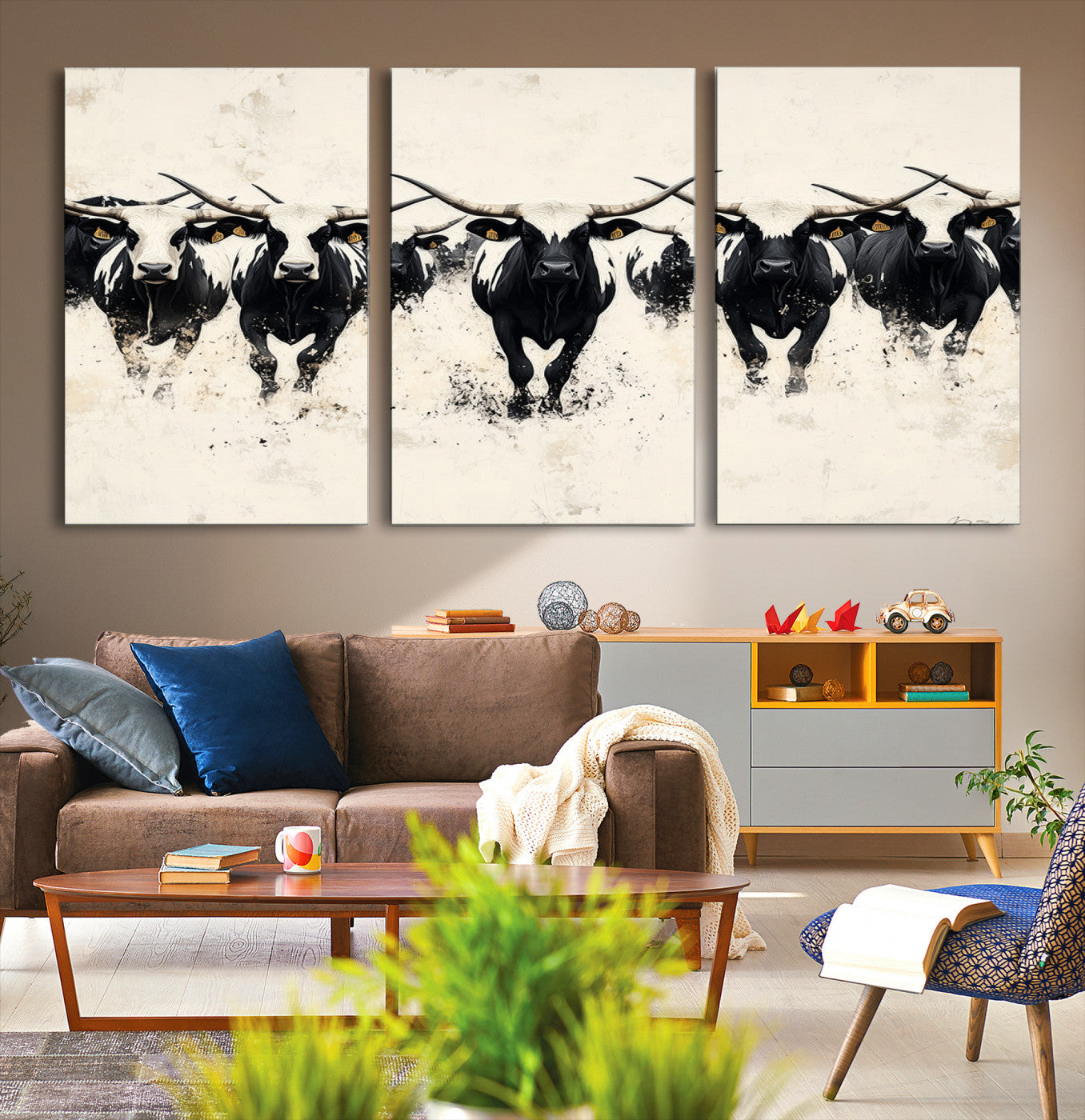 Canvas artwork of black and white Texas longhorns in a bold stampede over a minimalist background, ideal for rustic modern or Western-themed decor.