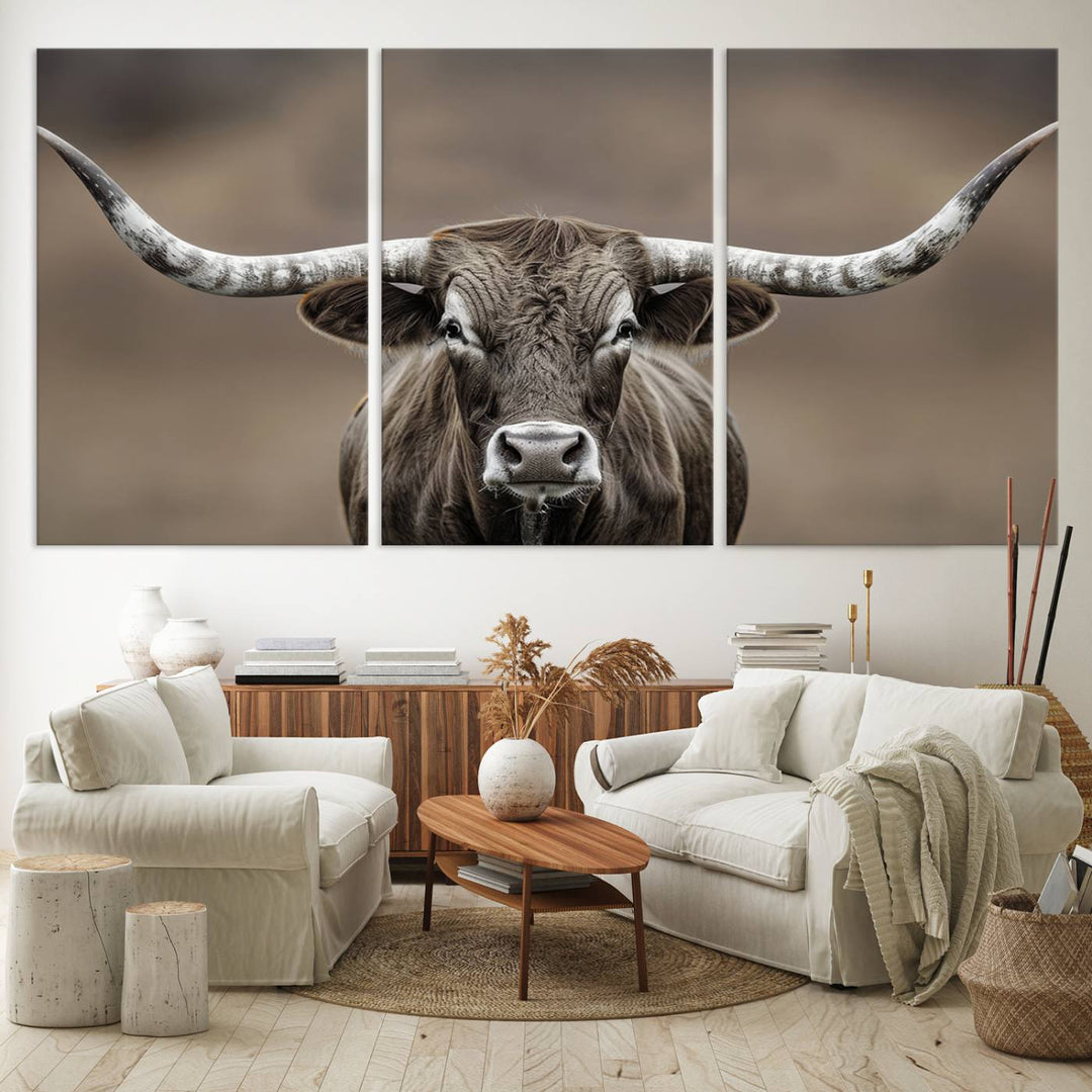 A close-up of a longhorn bull facing forward is featured in the Framed Texas Test-1, set against a blurred brown background.