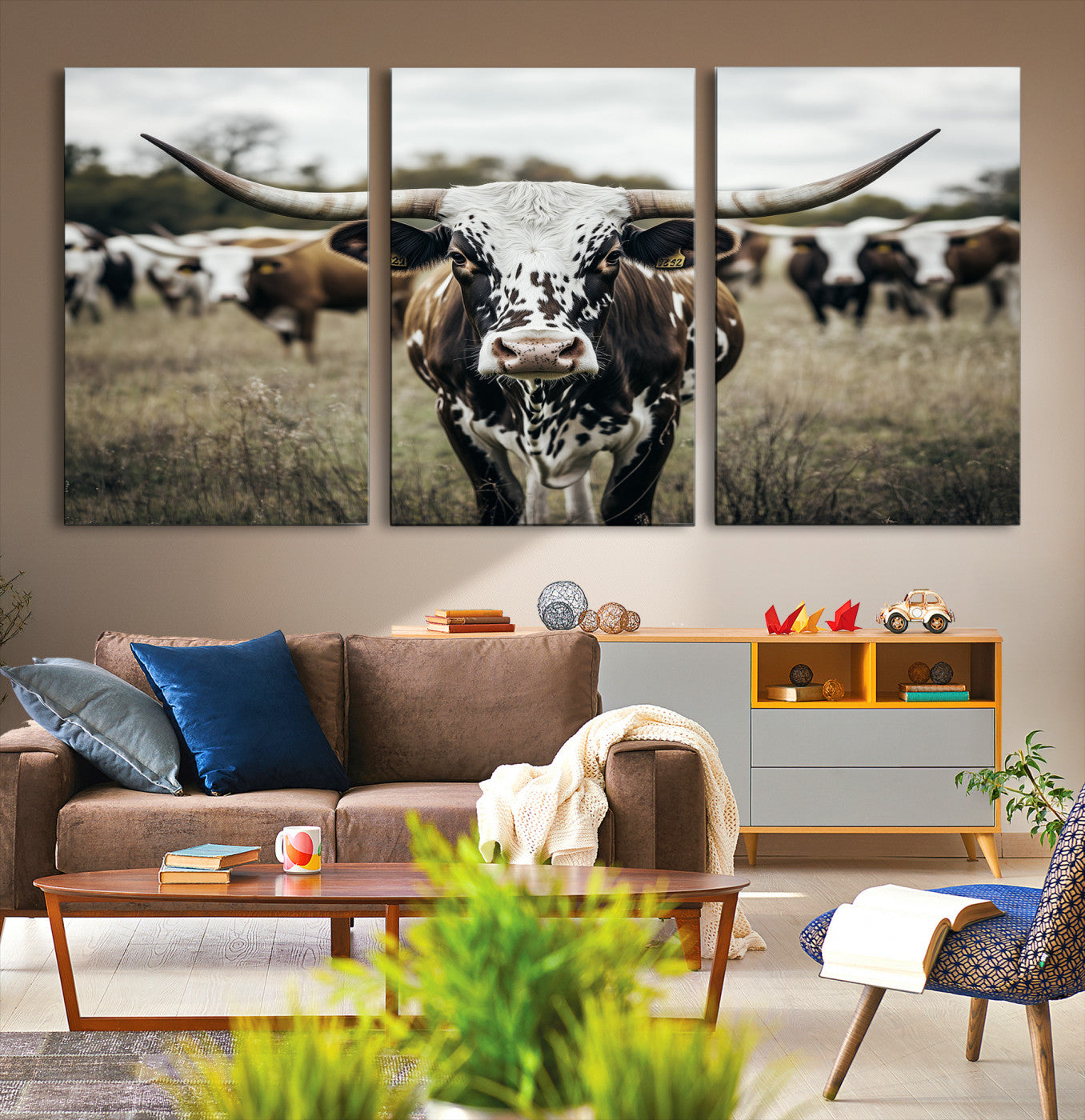 Canvas of a speckled Texas longhorn standing boldly in a field with a herd behind, perfect for rustic western or farmhouse wall decor.
