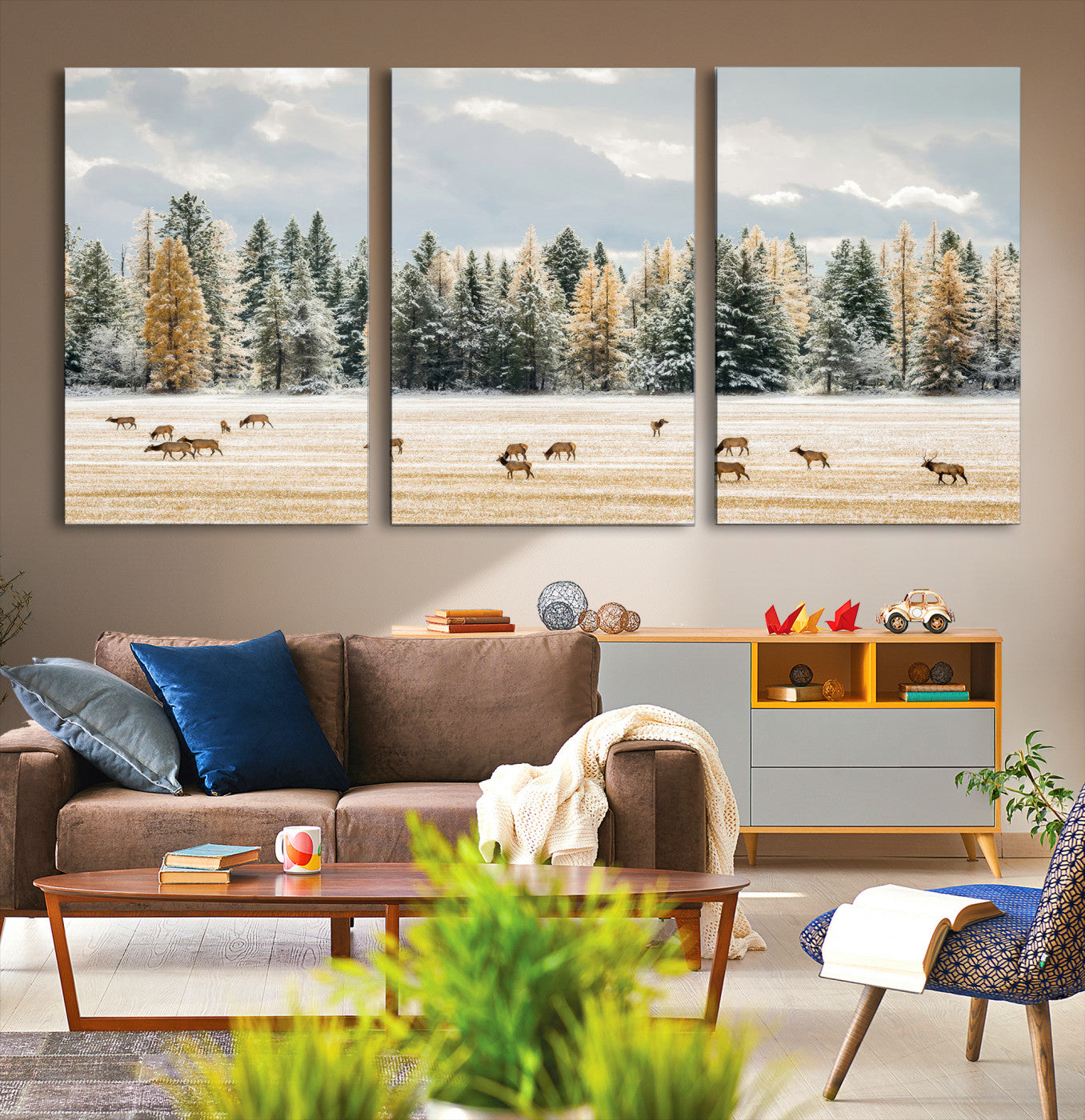 Elk herd in a snowy field with golden pine trees and frosted evergreens, ideal for neutral rustic or cabin-style home decor.