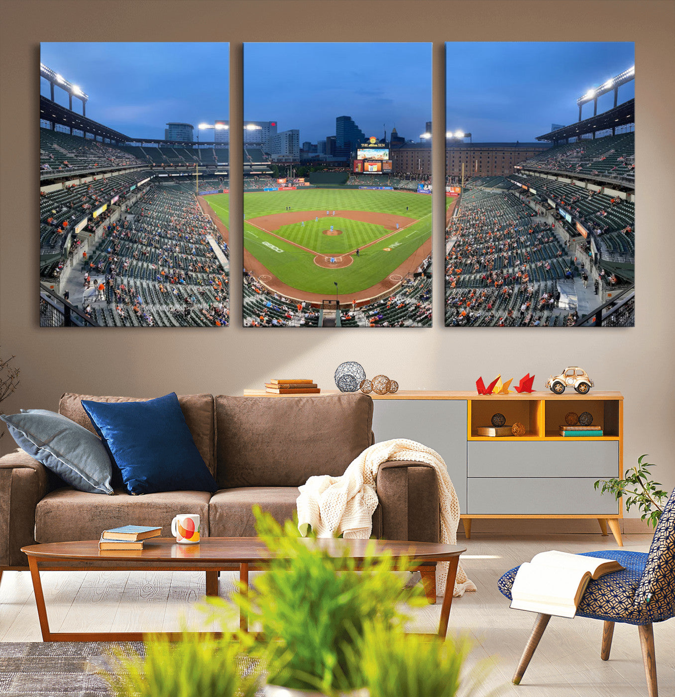 Wide panoramic view of a baseball stadium at dusk with players on the field, stadium lights illuminating the scene, and a sparse crowd of spectators in the stands.