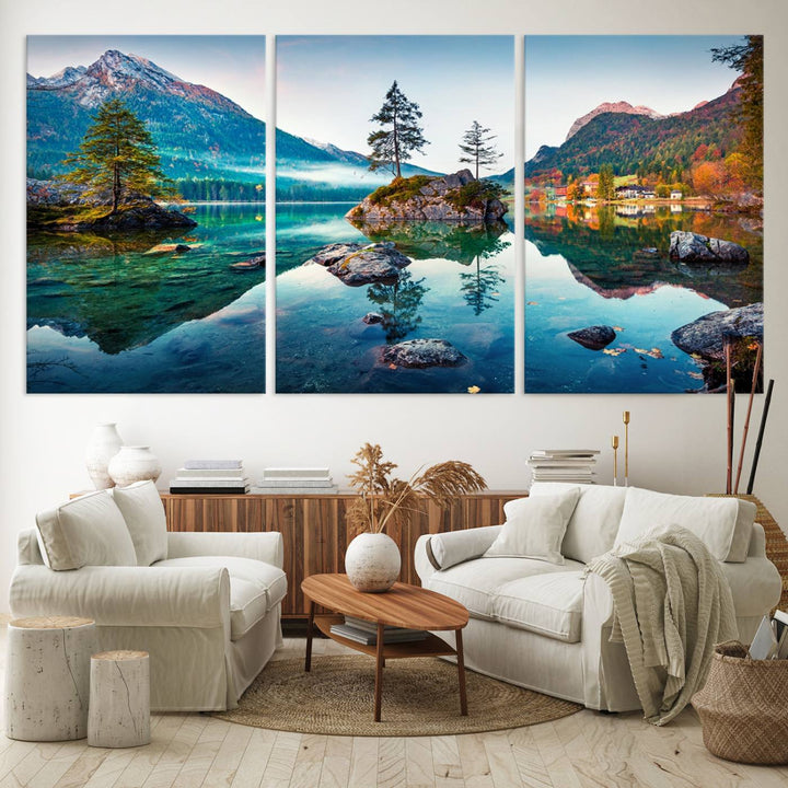 The 3-panel wall art showcases a serene mountain lake with rocky islands and trees, creating an ideal focal point for dining rooms or offices.