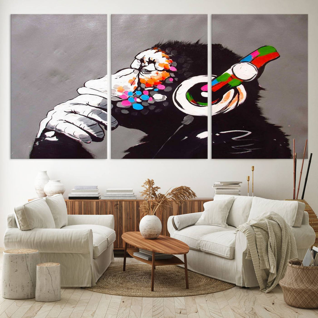 A vibrant triptych, the "DJ Monkey Listening to Music" wall art print, features a Banksy-inspired large canvas adorned with colorful modern pop art. This striking piece elegantly enhances the room with its dynamic and lively depiction.