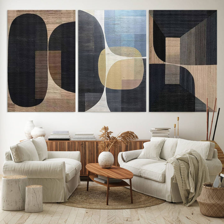 Abstract geometric wall art featuring black, gray, beige, and blue tones framed in a wooden border.