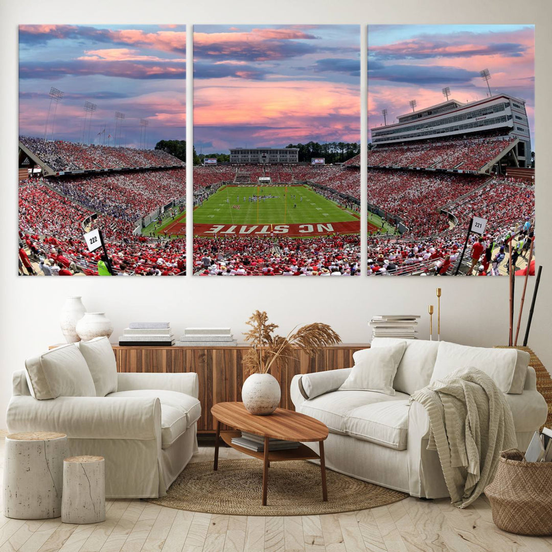 The wall art captures an NC State Wolfpack game under a vibrant sunset on triple canvas.