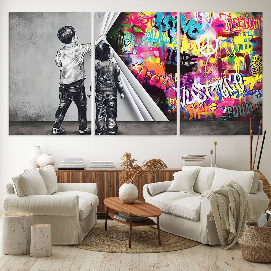 The Banksy Print - Street Art Canvas features a vibrant and bold image of two children lifting a curtain to reveal colorful graffiti. It's ready to hang, adding an urban modern decor vibe.