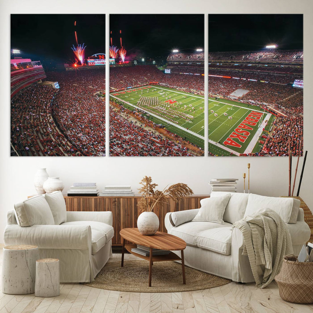 The University of Nebraska Cornhuskers Football Team Print, featuring Lincoln Memorial Stadium in a vibrant triptych canvas with fireworks above and a gallery-quality finish, is elegantly displayed.