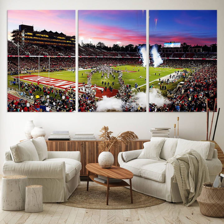 The wall art features a canvas print of the Stanford Cardinal football team, capturing players, fireworks, and smoke against the backdrop of a sunset at Stanford Stadium.