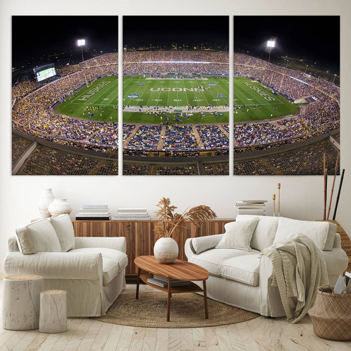 A large football stadium at night, featuring the UCONN Huskies, is depicted on the East Hartford Pratt & Whitney Stadium Wall Art Canvas Print.