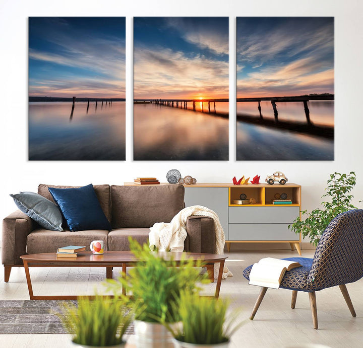 The Sunset Pier Canvas features a serene coastal landscape with vibrant hues under cloudy skies, ideal for modern decor.