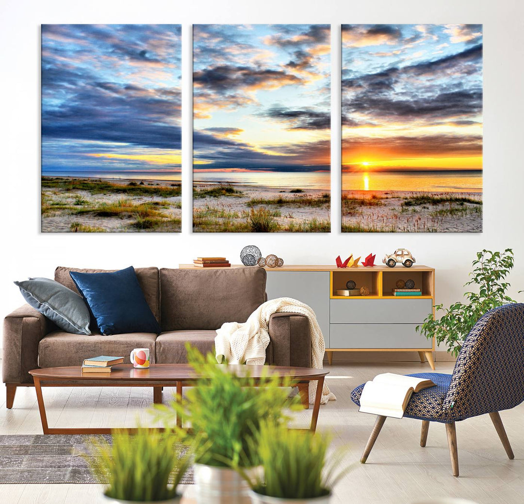 The Sunset On The Ocean canvas wall art features a beautiful beach sunset with grass and clouds.